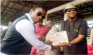 Anambra State Deputy Governor, Dr Nkem Okeke (right), presenting  Certificate of Registration  for Meritorious Youth Service to the representative of the Proprietor of Charity Ezeemo Trust, Mr Sochima Ezeemo in Awka, recently.