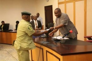 Rivers State Governor, Chief Nyesom Wike (right), receving a document from the state Comptroller of the Nigeria Immigration Service, Mr Ishaka Haliru, during a courtesy call on the governor at Government House, Port Harcourt, yesterday.