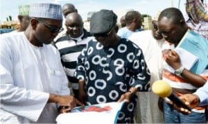 Governor Tanko Al-Makura of Nasarawa State (middle), inspecting the drawing for construction of Nyanya-Gwandara motor park, in his effort to decongest Abuja/Keffi highway in Lafia recently. With him are the Project Consultant, Mr Shehu Tukur (left) and others.