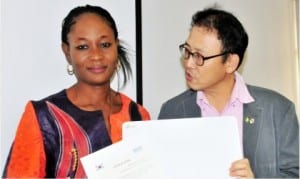 Country Director, Korea International Cooperation Agency in Nigeria (KOICA), Mr Jung Sang-Hoon (right), presenting an award to Bimbola Owojaiye, one of the champion students selected in e-Government Pilot Training under the auspices of KOICA,  in Abuja, last Friday