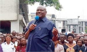 Governor Nyesom Wike (right),  addressing civil servants in Port Harcourt 