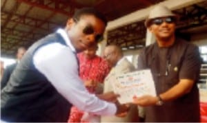 Anambra State Deputy Governor, Dr Nkem Okeke (right), presenting  certificate of registration  for meritorious youth service to the representative of the Proprietor of Charity Ezeemo  Trust, Mr Sochima Ezeemo, in Awka, recently.                       Photo: NAN