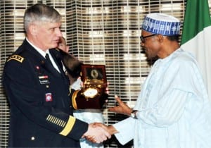 President Muhammadu Buhari (right), receiving a souvenir from the visiting Commander of the  US African Command, Gen. David Rodriguez  in Abuja on Wednesday