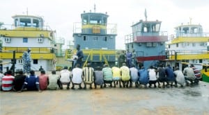 Security agents parading crew men of five vessels loaded with 108,000 litres of illegally refined automated gas oil in Port Harcourt, yesterday.