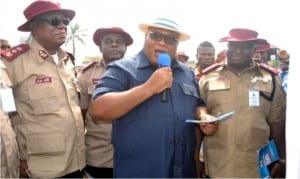 Secretary to Rivers State Government, Chief Kenneth Kobani (middle), addressing participants, during the ,Mega Rally organised by FRSC in Port Harcourt, yesterday. With him are A.A Abu (left) and Bisi Kazeem (right)