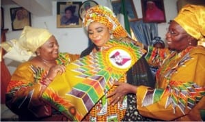 Nigerian Ambassador to Gambia, Amb. Esther Ausu (left) and President, FCT Indigenous Women Forum, Mrs Rifkatu Chidawa (right), decorating the President, National Council of Womewn Society (NCWS), Mrs Nkechi Mba, during a countesy visit by the members of the forum to NCWC Presidnet in Abuja on Wednesday.