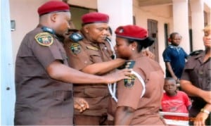 Rivers State Commander, Vigilante Group of Nigeria, Pastor Humphrey Opuada Gally (2nd left), and the Deputy Commandaer, Comrade Chukwuka Osumah (left), decorating the Commander of Abua/Odual Local Governemnt Area, Joy Davies with her new rank, during the dcoration of officers of the outfit in Oyigbo, yesterday.