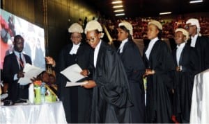 Secretary to Council and Director of Administration, Law School, Mrs Elizabeth Max-Uba (2nd right), presenting certificates to lawyers during their call to the Bar in Abuja, yesterday . With them is Administration Officer, Student Affairs Unit, Babatunde Tokosi (right).
