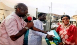 General Manager, Rivers State Broadcasting Corporation, Mr. Samson Fiberesima (left) and Chairman, NUJ, Radio Rivers Chapel, Comrade Walson Ibim Asako, presenting a souvenir to Dame Lizzy Fombo, former Director, News, Current Affairs, RSBC, during the sendforth ceremony of retired members of NUJ, in Port Harcourt on Wednesday.
