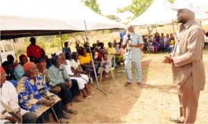 Representative of Project Director Naca/Sure-p, Dr Chukwugozie Ujam (right), addressing beneficiaries of NACA/SURE-P’s free  medical outreach at Akpasha Nkanu community in Enugu State on Monday