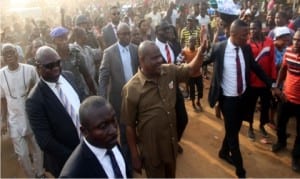 Governor Nyesom Wike of Rivers State (middle), acknowledging cheers from a jubilant crowd that trooped out to welcome him at Bishop Okoye Street in Mile 3 Diobu, Port Harcourt, during an inspection of road projects in the area on Monday