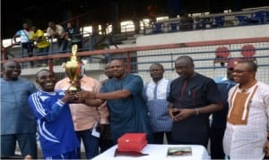 General Manager, Rivers State Newspaper Corporation, Mr Celestine Ogolo (right) and other dignitries look on as Rivers State Commissioner for Sports, Hon Boma Iyaye (4th left) presents the maiden Rivers SWAN Henry Kalio Cup to the captain of The Tide/Independent Monitor team, Isaac Mbah after the final match of the competition in Port Harcourt, yesterday 