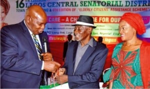 L-R: Lagos State Commissioner for Wealth Creation, Mr Tunde Durosinimi-Etti (left), presenting gifts to Elder Tayo Soyode, a recipient of Elderly Citizens Assistance Scheme, at the 16th edition of Lagos Central Senatorial District Town Hall meeting and 4th edition of Elderly Citizens' Assistance Scheme in Lagos, yesterday. With them is convener, Senator Oluremi Tinubu.
