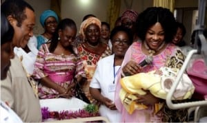 Wife of  Rivers State Governor, Justice Suzzette Nyesom Wike (right), admiring the New Year baby born to Mr and Mrs  Harrison at the University of Port Harcourt Teaching Hospital on New Year Day. With her is Chief Medical Director of the hospital, Prof Aaron Ojule (left).