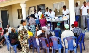 Medical officers  attending to people, during the National Agency for Control of AIDS/SURE-P free medical outreach  in Isuochi community in Abia State, recently