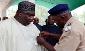 Governor Ifeanyi Ugwuanyi of  Enugu State (left), being decorated with the  2016 Armed Forces Remembrance Day Emblem by Chairman, Nigeria Legion, Enugu State Council, Mr George Amalu  in Enugu, yesterday