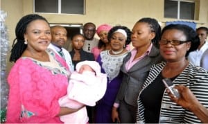 Wife of Enugu State Governor, Mrs Monica Ugwuanyi (left), carrying the First Baby of the Year at Parklane Hospital, Enugu, Miss Adora Chiaha  