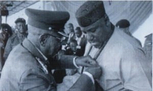 Governor Rochas Okorocha of Imo State (right), being decorated by the State Chairman of Nigeria Legion, Lt-Col Damian Okafor (rtd), with the Armed Forces Remembrance Emblem, in Owerri on Wedneday