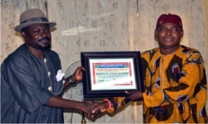 Federal Commissioner, representing  Rivers State in the  Public Complaints Commission,  Dr.  Alpheus Paul-. Worika (left), receiving an Award of Patronship from the President General, League  of Characters Club,  Chief  Christain  Kokoriko, during an official visit of the club to the commission, in Port Harcourt, yesterday.         Photo: Nwiueh Donatus Ken 