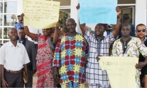 Members of the Joint Federal Staff Co-operative Thrift and Loans Society, agitating for removal of their Chairman, Mr Sunday Antai, at Radio House in Abuja yesterday 