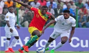 A Guinea play (left) forcing his way past a Nigerian defender during the CHAN last Group C match in Rubaru, Rwanda, yesterday.