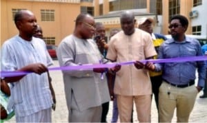 Representative of the sponsor  of  Go Round/SWAN Secondary School Athletics Championship. Chief Ike Chukwu (2nd left),  cutting the tape to unveil new branded buses donated to the Main Organising Committee (MOC) of the championship in a brief ceremony, in Port Harcourt, yesterday. With him are  the MOC  Chairman, Honour Sirawoo (2nd right), Media/ Publicity Chairman, Gabriel Nwanetanya (left) and Chairman, Transport/Logistics Committee, China Acheru .       Photo: Chris Monyanaga 