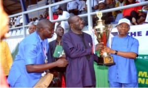 Sponsor of Go Round/SWAN Athletics Championship, Bro Felix Obuah (middle), presenting the Overall Best Athlete Trophy to PHALGA CTC Chairman, Hon Samuel Ejekwu (right), while MOC Chairman, Honour Sirawoo (left) looks on.