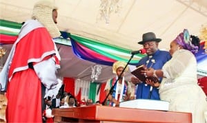 Chief Judge of  Bayelsa State, Justice Kate Abiri (left), administering oath of  office on    Governor Seriaki Dickson of Bayelsa State  in Yenagoa,  yesterday.  With them  is the governor’s wife,  Rachael.