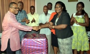 General Manager, Rivers State Nespaper Corproation, Mr Celestine Ogolo (left), in a handshake with a retired staff of the corporation, Mrs Fyne West (2nd right), during a sendforth party organised in her honour in Port Harcourt on Monday. Photo: Ibioye Diama