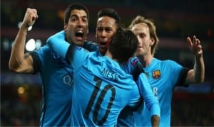 Lionel Messi and his team mates celebrating his first goal yesterday against Arsenal during the Champions League match. Barca won by 2-0