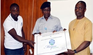 L-R: Managing Director, MAYSU Construction Ltd., Mr Hart Bankat, Minister of Youth and Sports Development, Mr Solomon Dalung, and Permanent Secretary, Mr Christian Ohaa, displaying the drawing for the National Stadium complex in Surulere, Lagos to be rehabilitated, at a news conference in Abuja, recently.