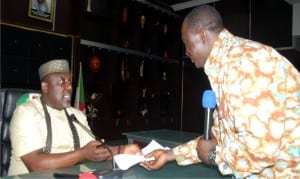 Governor Rochas Okorocha of Imo State (left), receiving a copy of the signed agreement between government and labour from the National President of Nigeria Labour Congress, Comrade Ayuba Wabba, at the Government House in Owerri, recently.