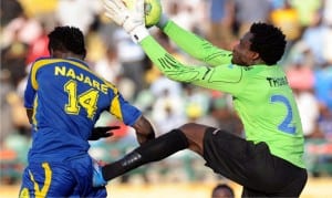 Keeper Femi Thomas (right) of Enyimba going for the ball