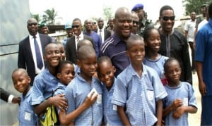 Rivers State Governor, Chief Nyesom Wike, with pupils of Santa Maria Nursery and Primary School in Port Harcourt shortly after inspecting work on the NLNG-Nkpogu bridge in Port Harcourt, on Friday.