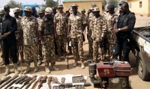 Chief of Army Staff, lt.-Gen. Tukur Buratai (4th right), with by senior army officers while inspecting weapons recovered from suspected Boko Haram terrorists, during his visit to Damboa LGA headquarter on Saturday