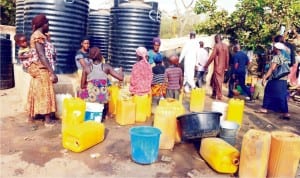 Internally Displaced Persons (idps) fetching water from a bore hole in their New Kuchingoro Camp in Abuja, yesterday.