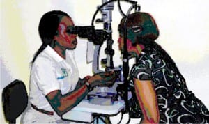 Head of Department, Ophthalmology, Garki Hospital, Dr Bitto Sewueze attending to a patient during free eye screening to mark 2016 World Glaucoma Week in Abuja last Tuesday.