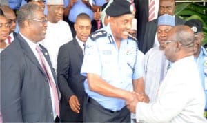 I-G Solomon Arase, (middle), in a handshake with the Coordinating Director Firs, Mr Ajayi Bamidele , during the visit of delegations of Joint Task Board of Firs To Inspector-General of Police in Abuja recently. With them is the Executive Chairman, Firs Mr Tunde Fowler (left)