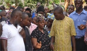 Mrs Blessing Innocent Ohanuna (centre) wife of late Innocent bidding farewell to her late husband at the grave side.