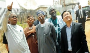 Managing Director, tv Enterprises, Mr Maxwell Loko  (left) Minister of Information, Mr Lai Mohammed (middle) during the  minister's inspection of nta digitisation facilities in Jos. With them are other government officials.
