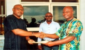 State Chairman NUJ Comrade Ayo Tamuno (right),  giving Partnership Document to Managing Partner Bonny Tawheel Global Resource Ltd, Mr. Owanari Batubo recently at Press Centre Port HarcourtPhoto: Obinna Dele Prince