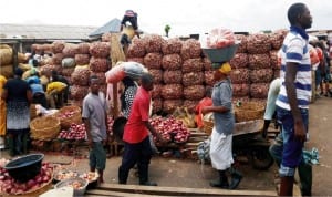 Bags of onions being offloaded at Mile 12 Market Lagos State after the reopening of the market.