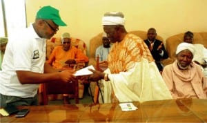 Zonal Coordinator, North Central, National Film and Video Censors Board, Mr Ailewon Danlami (L), presenting letter of partnership to Chief Imam of Jos, Sheik Lawan Adamu, during the Media Literacy Project and Sensitisation on Nigeria Movies to the public in Jos.With them is the administrative secretary, Jama'atu Nasril Islam Sheik Abdulaziz Yusuf.