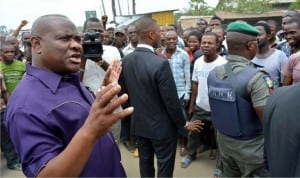 Rivers  State Governor, Chief Nyesom Wike (left) , addressing people of Etche, during his inspection tour of  on-going road reconstruction project at Etche-Chokocho Road in  Etche Local Government of Rivers State recently 