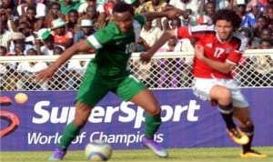 Super Eagles captain, Mikel Obi (left) being pressurised by Egypt’s Mohammed Elneny, during Nigeria/Egypt first leg clash in Kaduna, recently.