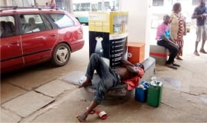 A customer taking a nap at a filling station in Benin City after waiting for so long to buy fuel last Sunday