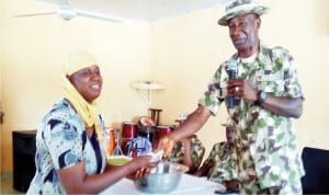 goc, 7th Division of the Nigerian Army Maiduguri, Brig.-Gen. Victor Ezugwu (right) presenting cash to a beneficiary of soft loans to unemployed youths and women groups under the Chief of Army Staff Empowerment Initiatives to barracks community in Maiduguri on Sunday.