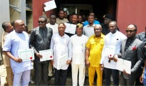 Cross Section of 11 members of the Rivers House of Assembly with the Resident  Electoral Commissioner,Mr Aniedi Ikoiwak(middle) after receiving their Certificate of Return in  Port Harcourt  last Friday.
