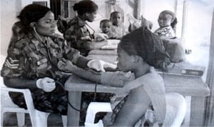 Nigerian Air Force Medical Staff checking the blood pressure of a woman during the medical outreach carried out by 39 Base Services Group (BSG) of the Nigerian Air Force in Emene Community, Enugu State on Monday