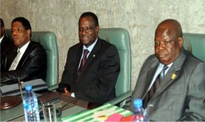 L-R: Incoming President of ECOWAS Commission, Alain Marcel De Souza, the outgoing President, Kadre Desire Ouedraogo and the representative of Minister of State for Foreign Affairs, Mr Manaja Isa, during the ECOWAS Commission Presidential hand-over in Abuja on Friday